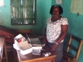 Ms Koroma with laptop and stationery donated by Dobbs on her second visit